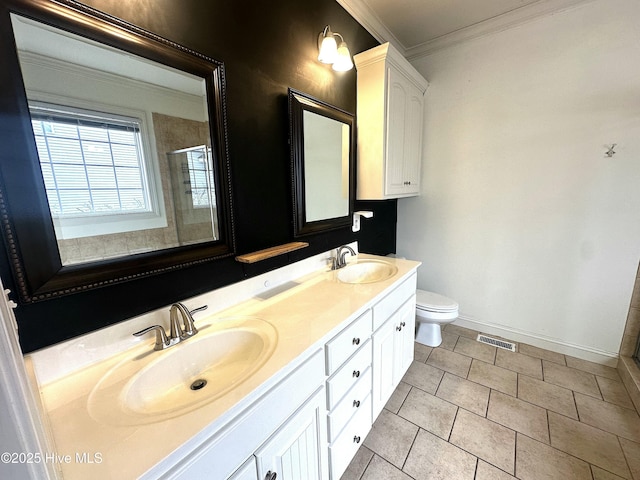 bathroom featuring ornamental molding, vanity, toilet, a shower with door, and tile patterned floors