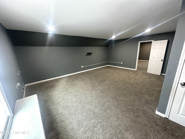 basement featuring dark carpet