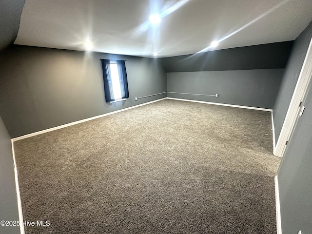 interior space featuring vaulted ceiling and carpet floors