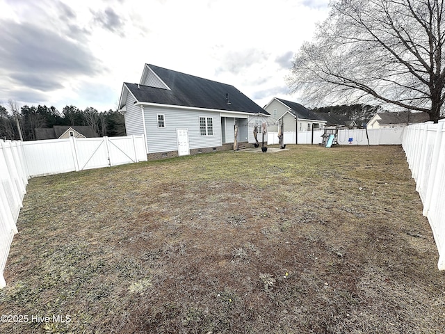 back of house with a lawn