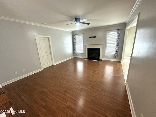 unfurnished living room with crown molding, ceiling fan, and dark hardwood / wood-style floors