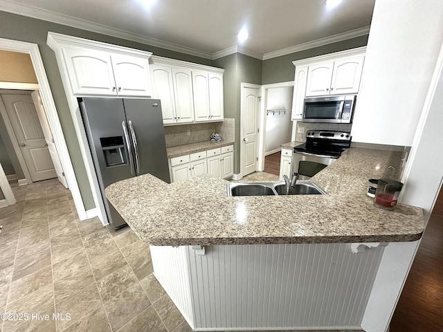 kitchen with a breakfast bar, sink, white cabinets, kitchen peninsula, and stainless steel appliances