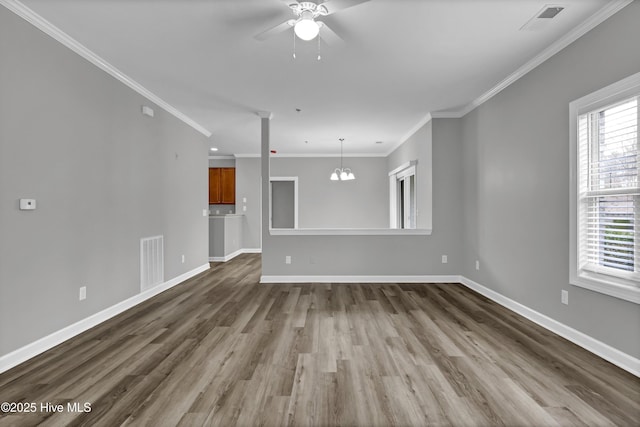 unfurnished living room with crown molding, ceiling fan with notable chandelier, and hardwood / wood-style floors