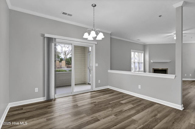 unfurnished dining area with crown molding, dark hardwood / wood-style floors, and ceiling fan with notable chandelier