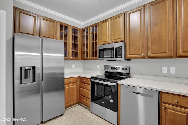 kitchen featuring light stone counters, ornamental molding, and appliances with stainless steel finishes