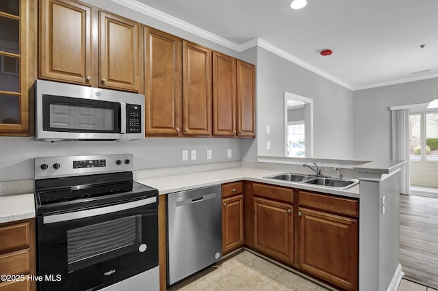 kitchen with light tile patterned flooring, appliances with stainless steel finishes, sink, kitchen peninsula, and crown molding