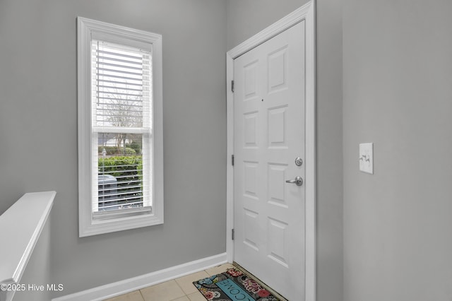 doorway to outside with light tile patterned floors