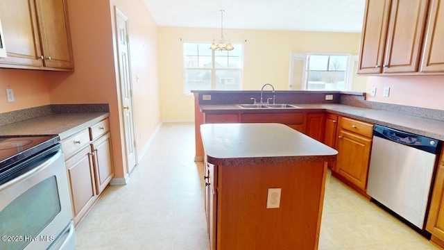 kitchen featuring stainless steel appliances, hanging light fixtures, sink, and a kitchen island