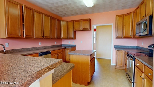 kitchen with a kitchen island and appliances with stainless steel finishes