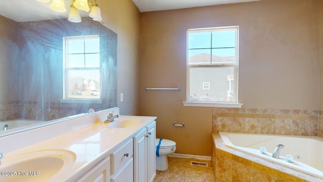 bathroom featuring vanity, toilet, tile patterned flooring, and tiled bath