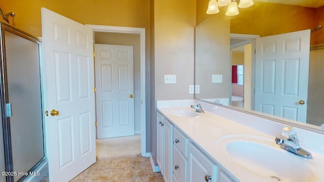 bathroom featuring tile patterned flooring, vanity, and a shower with shower door