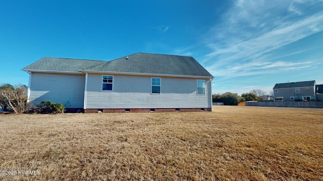 rear view of house featuring a yard