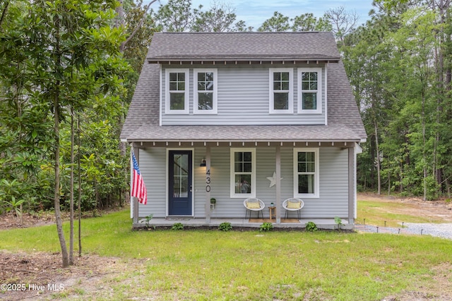 view of front of property with covered porch and a front lawn