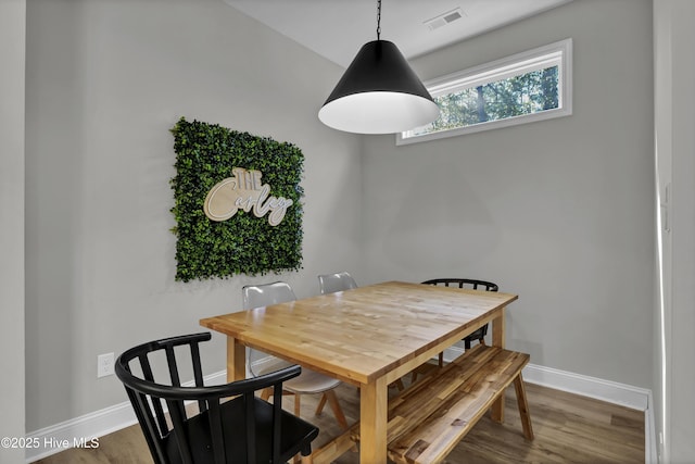 dining area with hardwood / wood-style floors