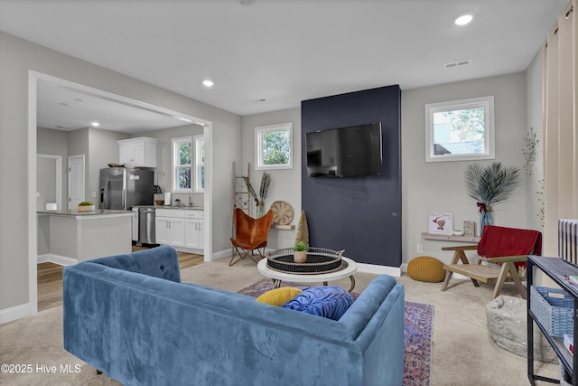 living room featuring radiator heating unit and sink