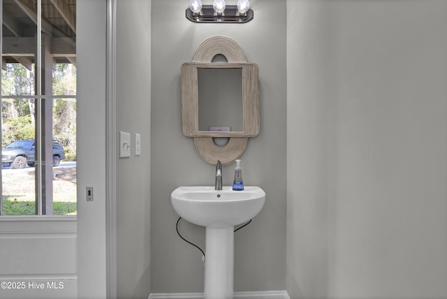 bathroom with a chandelier and a healthy amount of sunlight