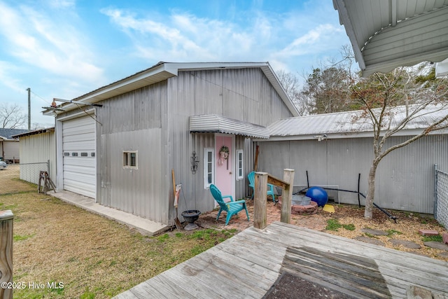 view of outbuilding featuring a garage and fence