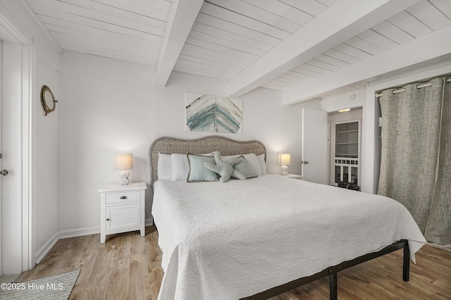 bedroom with wooden ceiling, baseboards, beamed ceiling, and light wood finished floors