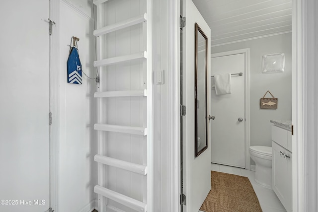 bathroom with vanity, tile patterned flooring, and toilet