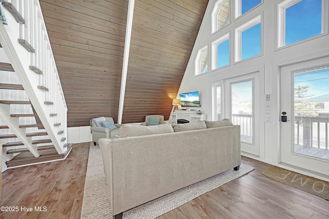 living room featuring high vaulted ceiling, wood ceiling, stairway, and wood finished floors