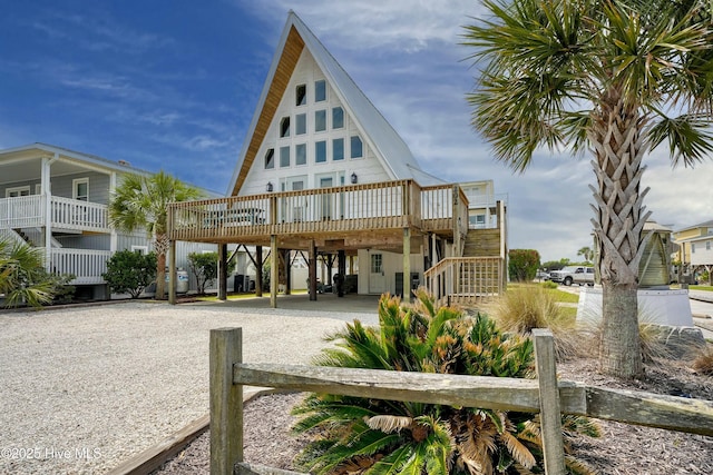 view of building exterior featuring driveway and stairway