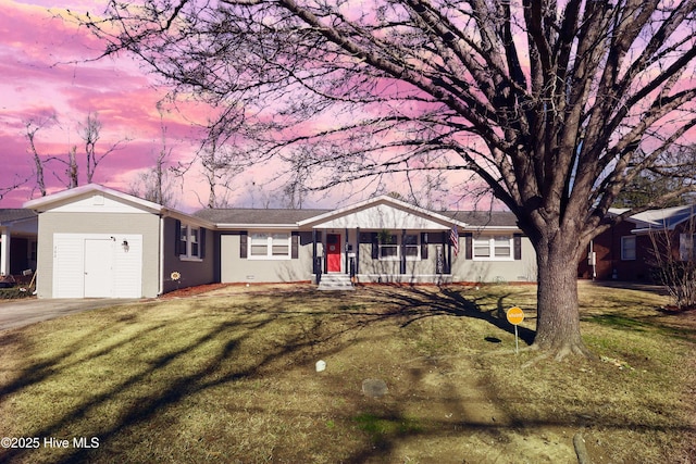 ranch-style house with brick siding and a lawn