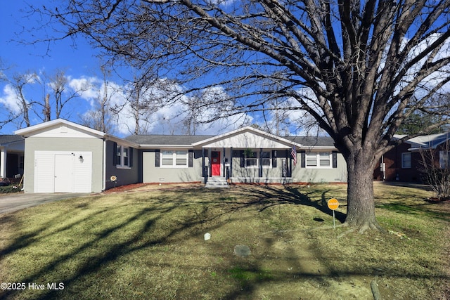 single story home featuring driveway, a front lawn, and brick siding