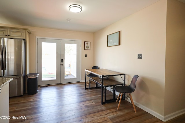 dining area with baseboards, dark wood finished floors, and french doors