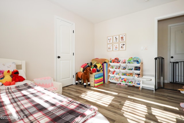 bedroom with dark wood-style flooring