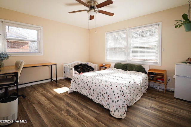 bedroom featuring dark wood-style flooring, multiple windows, and baseboards