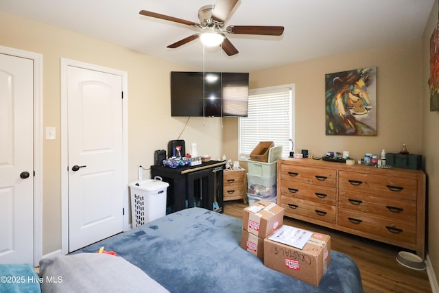 bedroom featuring ceiling fan and dark wood finished floors