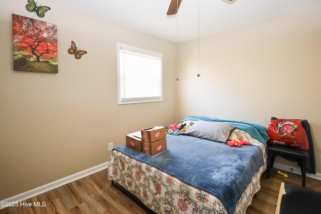 bedroom with dark wood-style floors, baseboards, and a ceiling fan