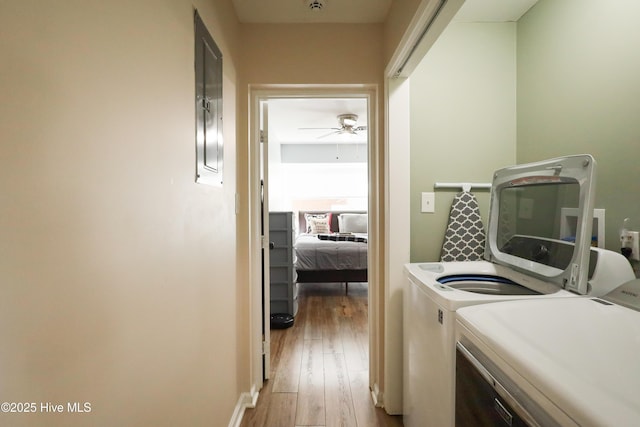 clothes washing area with light wood-type flooring, washer and dryer, laundry area, and a ceiling fan