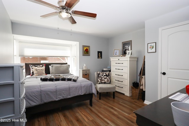 bedroom with ceiling fan, dark wood-style flooring, and baseboards