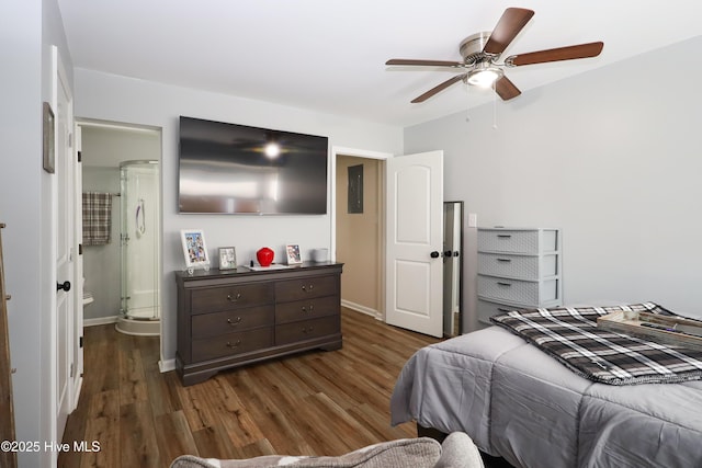 bedroom featuring dark wood-style floors, ceiling fan, baseboards, and ensuite bathroom