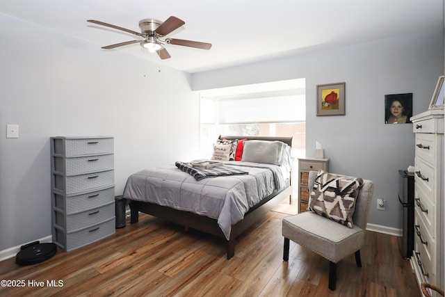 bedroom with baseboards, dark wood finished floors, and a ceiling fan