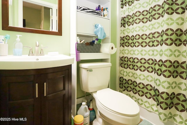 full bathroom featuring curtained shower, vanity, and toilet