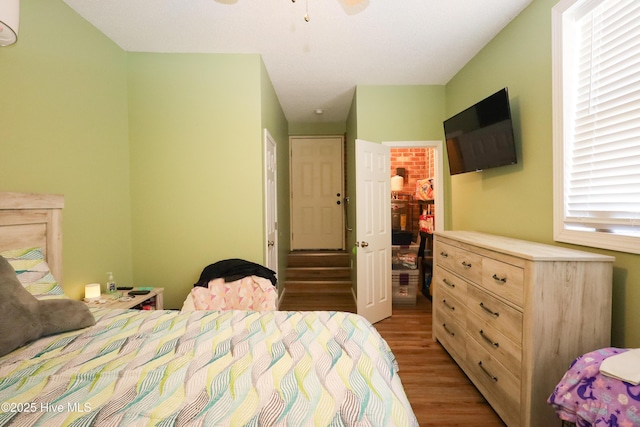 bedroom with light wood-type flooring, a walk in closet, and a closet