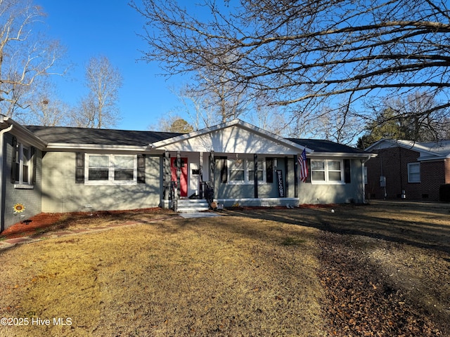 ranch-style home with a front yard, covered porch, and brick siding