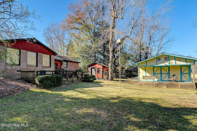 view of yard with a wooden deck, a porch, and a storage unit