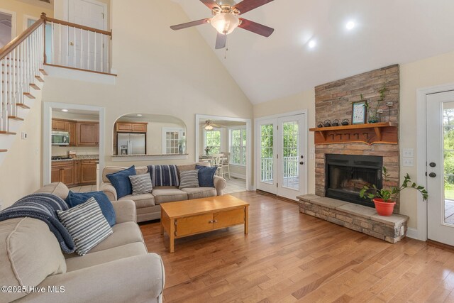 232 E Ivybridge Dr, Hubert, NC 28539 - living area featuring ceiling fan, high vaulted ceiling, light wood-style flooring, a fireplace, and stairway