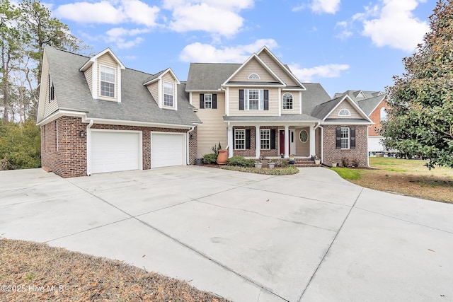 view of front of house featuring driveway, a porch, and brick siding