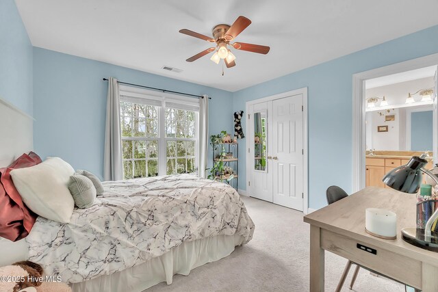 232 E Ivybridge Dr, Hubert, NC 28539 - bedroom with light carpet, ceiling fan, and ensuite bathroom
