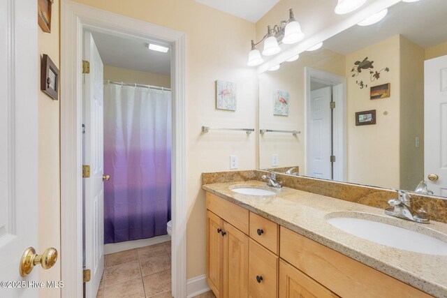232 E Ivybridge Dr, Hubert, NC 28539 - full bathroom with double vanity, tile patterned floors, a shower with curtain, and baseboards