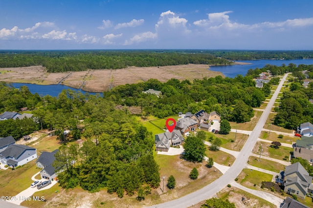 232 E Ivybridge Dr, Hubert, NC 28539 - aerial view of residential area with a nearby body of water and a heavily wooded area