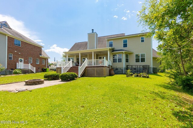 232 E Ivybridge Dr, Hubert, NC 28539 - back of house featuring a fire pit, a chimney, a yard, and central AC