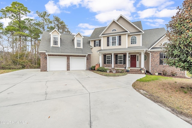 view of front of home with concrete driveway, a shingled roof, a porch, brick siding, and a garage