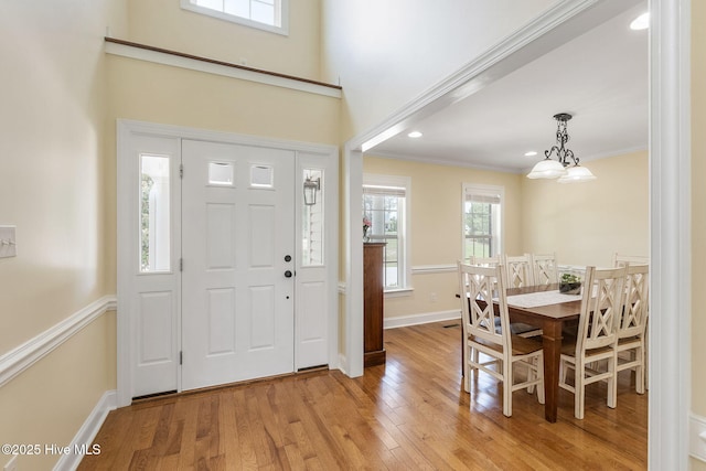 232 E Ivybridge Dr, Hubert, NC 28539 - foyer entrance with light wood-style flooring, baseboards, a chandelier, crown molding, and recessed lighting