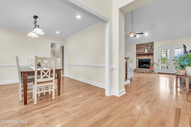 232 E Ivybridge Dr, Hubert, NC 28539 - dining room with ceiling fan, light wood-style floors, a stone fireplace, baseboards, and ornamental molding