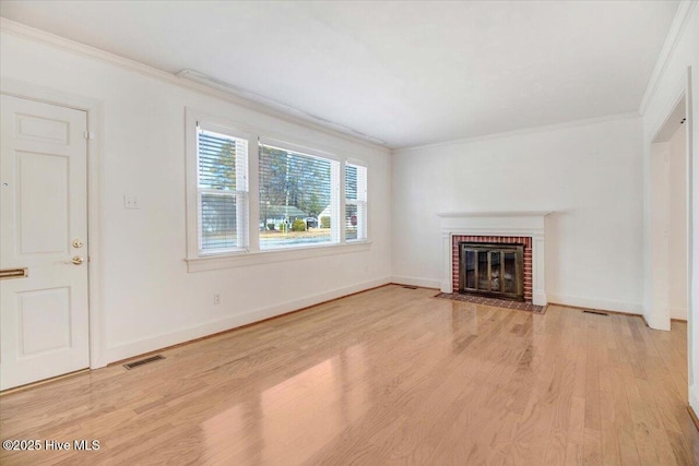 unfurnished living room with ornamental molding, a fireplace, and light wood-type flooring